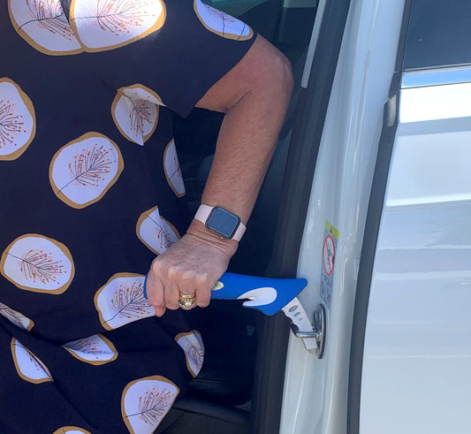 person using a Car Door Assist in a car door striker