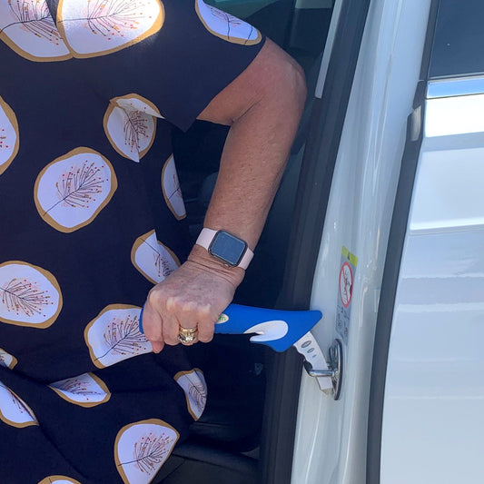 person using a Car Door Assist in a car door striker