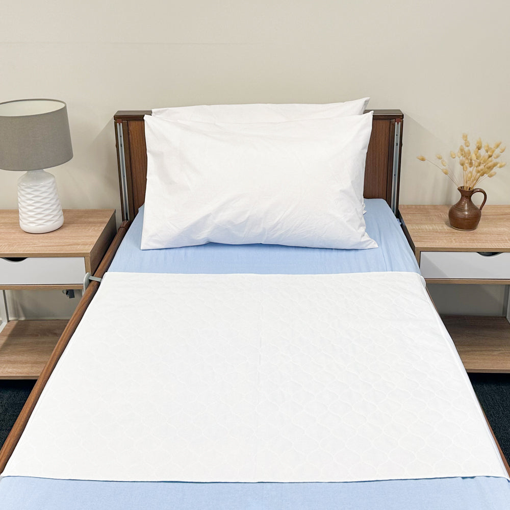 Absorb Plus Lightweight Bed Pad with Flaps on bed