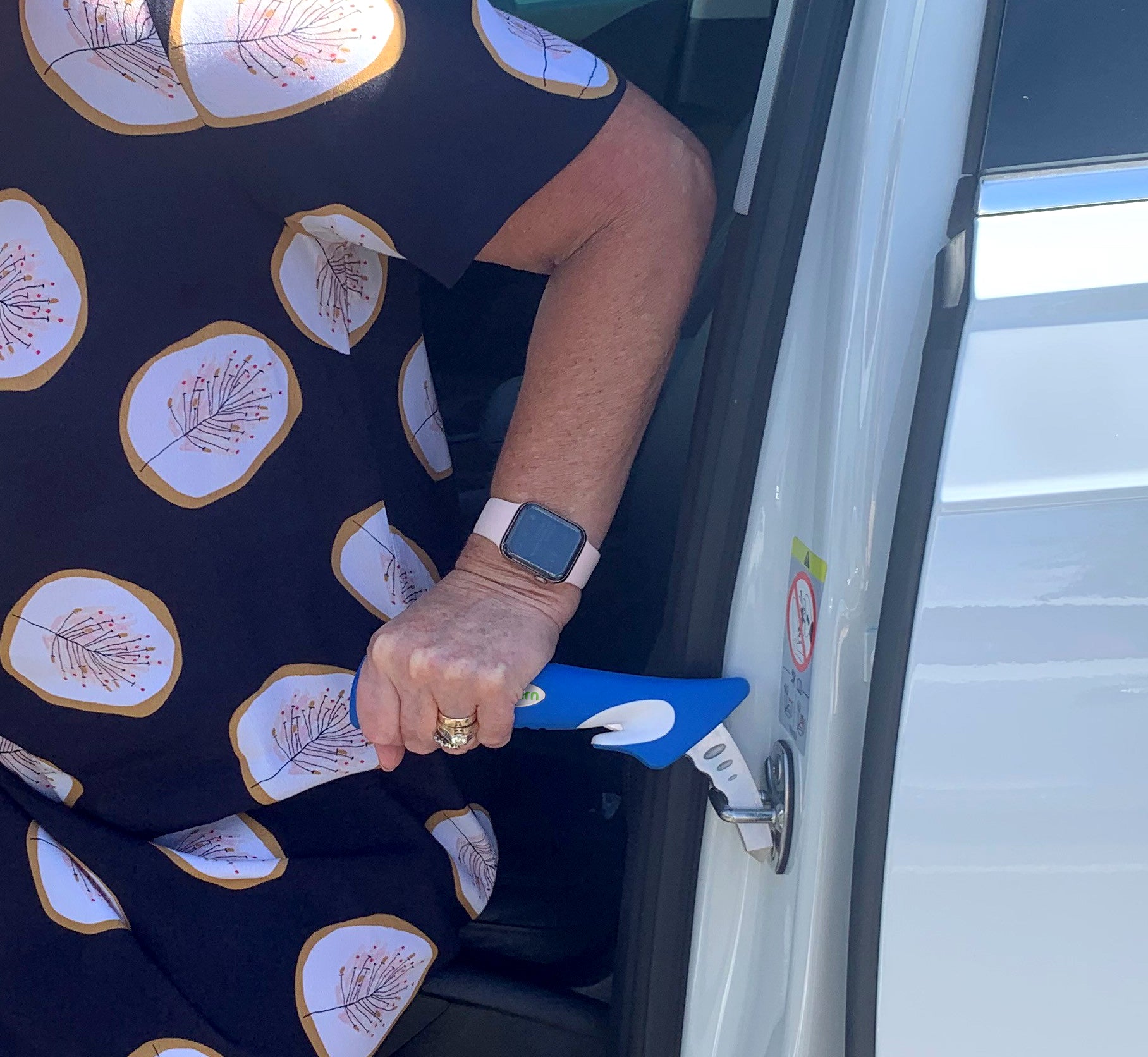 person using a Car Door Assist in a car door striker