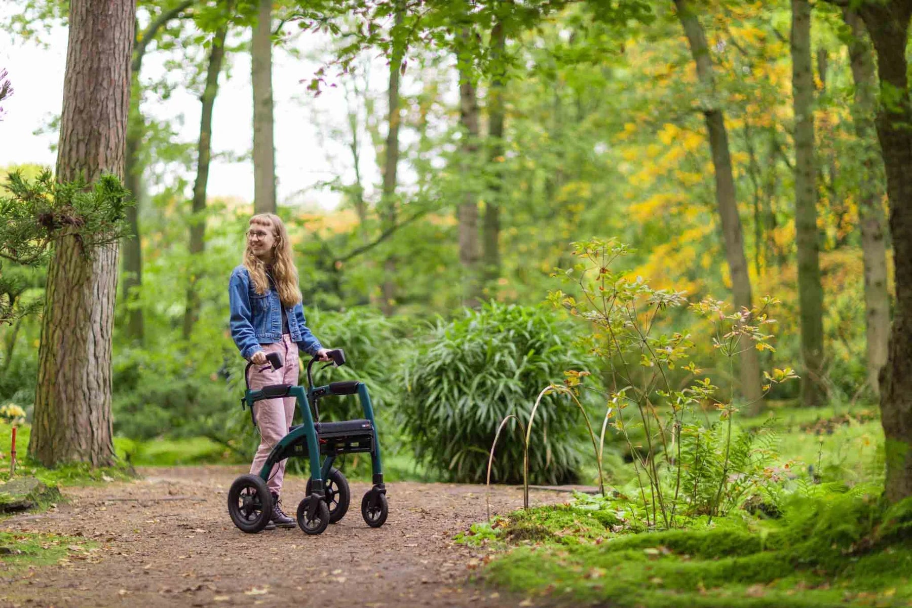 Woman with a Rollz Motion Performance 2-in-1 Walker Wheelchair in a park setting