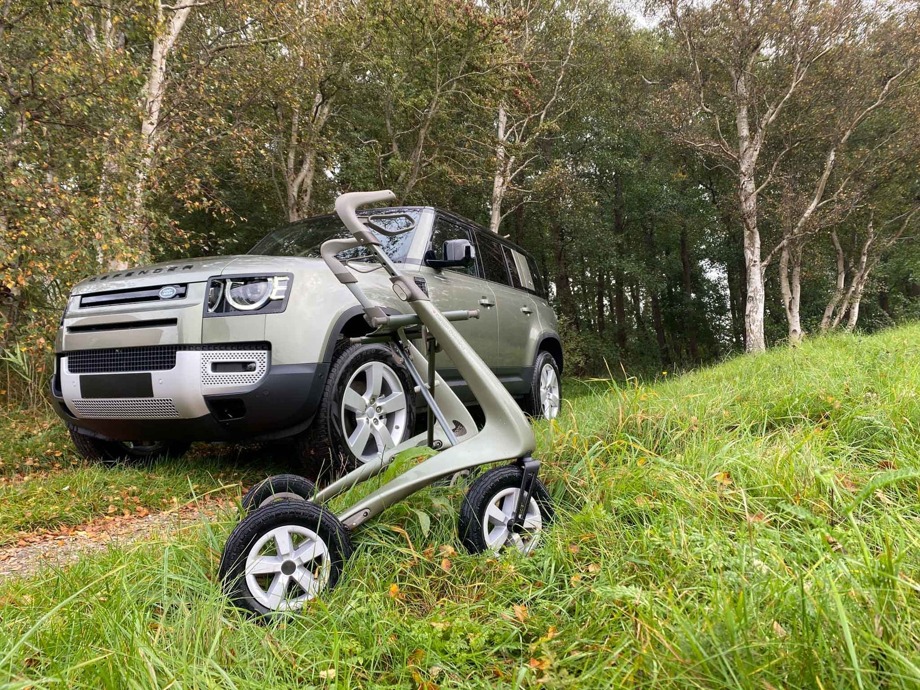 byACRE Carbon Overland Walker outdoors next to Landrover Defender Green