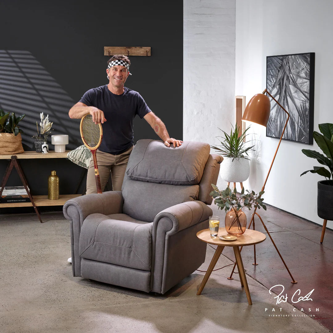 Man standing next to a Theorem Studio Power Lift Recliner Chair in Fog in a modern living room.
