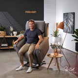 Man sitting in a Man standing next to a Theorem Studio Power Lift Recliner Chair in Fog in a modern living room.