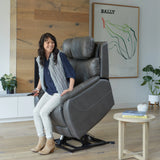 Woman sitting in a Theorem Winslow Power Lift Recliner Chair in a modern living room.