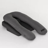 A dark gray U-shaped icare body pillow pregnancy support pillow with a matching icare Supporta Rotator Cuff Recovery Pillow underneath, shown on a light gray studio background. The brand name 'icare' is printed on the side of the U-pillow.