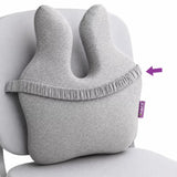 A icare Reform Full Back Support cushion with back elastic strap, shown resting on a white chair. A purple arrow points to the side of the pillow where a small purple 'care' brand tag is attached.