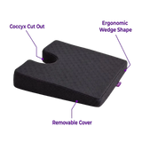 A charcoal icare Coccyx Wedge with a textured top surface, shown on a white background with purple text callouts highlighting features like the 'Coccyx Cut Out,' 'Ergonomic Wedge Shape,' and 'Removable Cover.'.