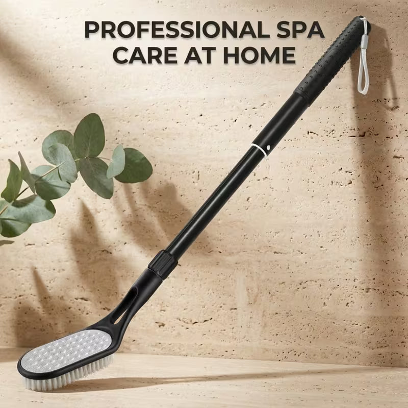 A long-handled black spa scrub brush with a textured grip and wrist strap, leaning against a beige stone wall with the text 'PROFESSIONAL SPA CARE AT HOME' above it.