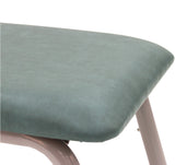 Close-up of a padded upholstered surface in a muted sage green color, showing part of the rounded corner and a light pink metal support leg against a white background.