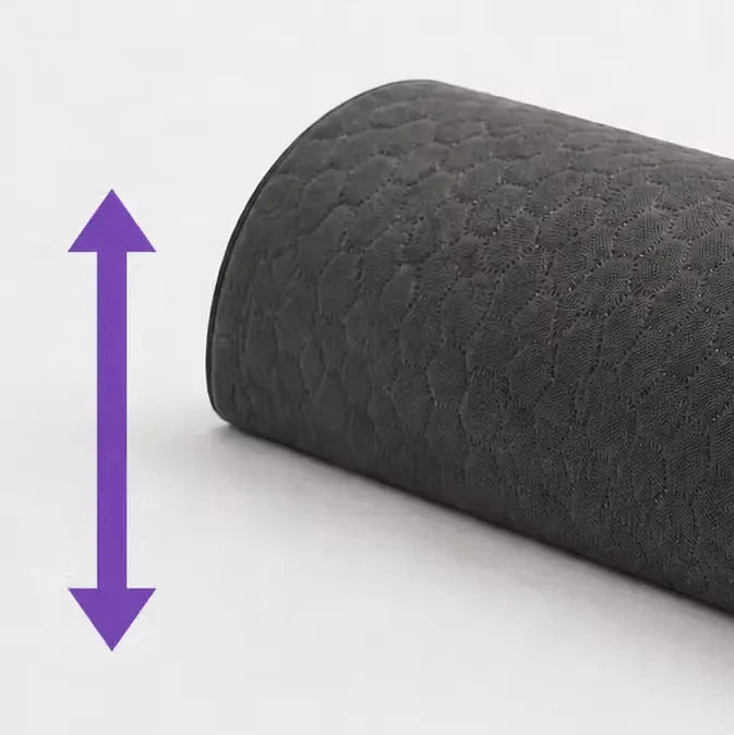 A close-up of a charcoal icare Supporta half Lumbar Roll, likely a rolled mat or cushion, shown on a light gray background with a purple double-arrow graphic indicating height or thickness.