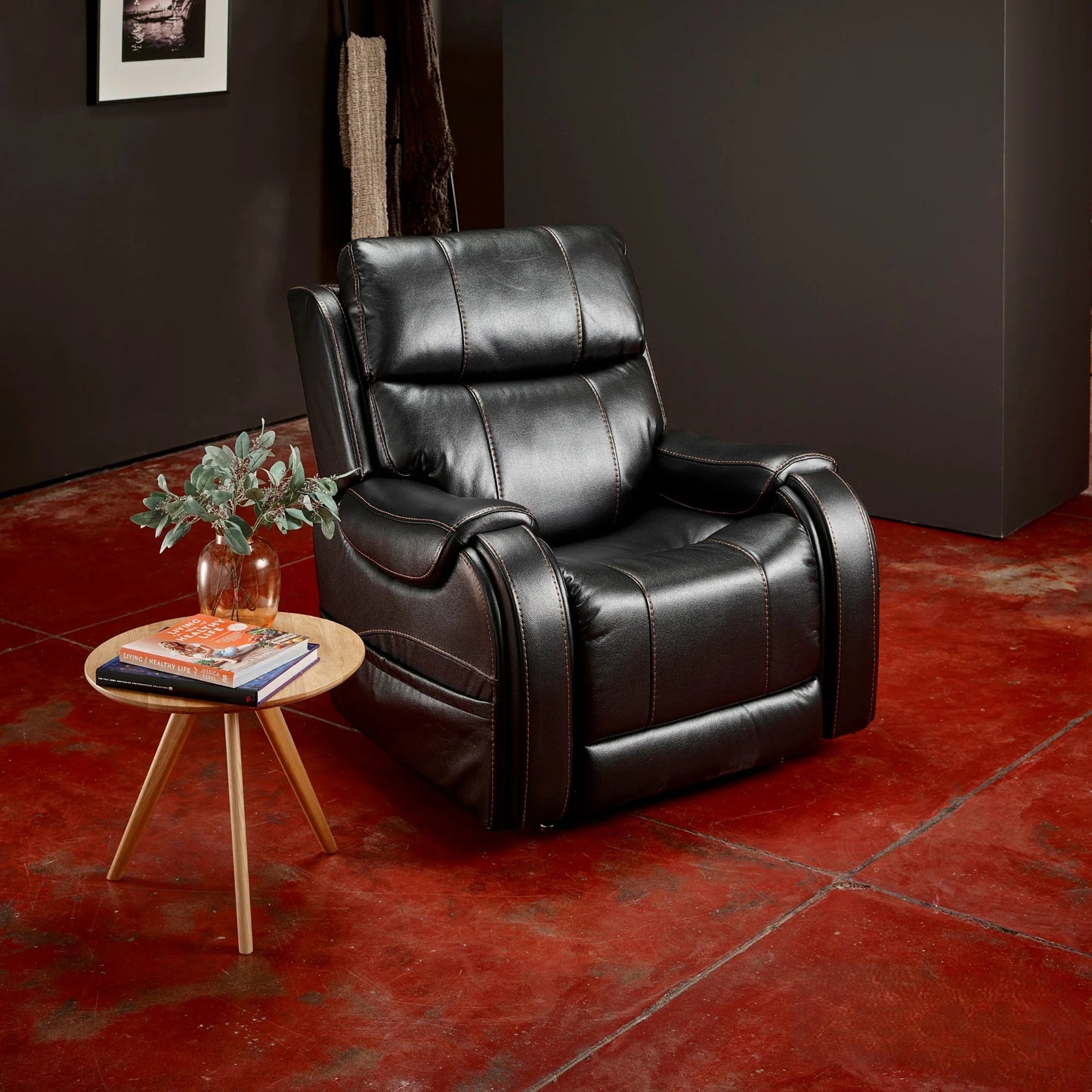 A Midnight Theorem Seagrove Power Lift Recliner Chair in a room with a small round table and plant.