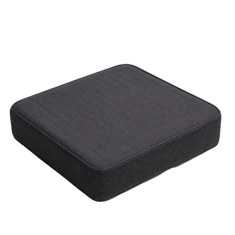 A charcoal 10cm icare Supporta Seat Cushion with a quilted top surface and a small purple tag, shown on a light gray studio background.