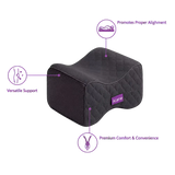A charcoal icare Supporta Knee Cushion  with purple text callouts highlighting its benefits: 'Promotes Proper Alignment,' 'Versatile Support,' and 'Premium Comfort & Convenience.' The brand name 'icare' is visible on a small purple label on the front of the pillow.