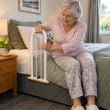 Woman using a Tas-Tech Bed Lever with Cord & Cleat in bedroom