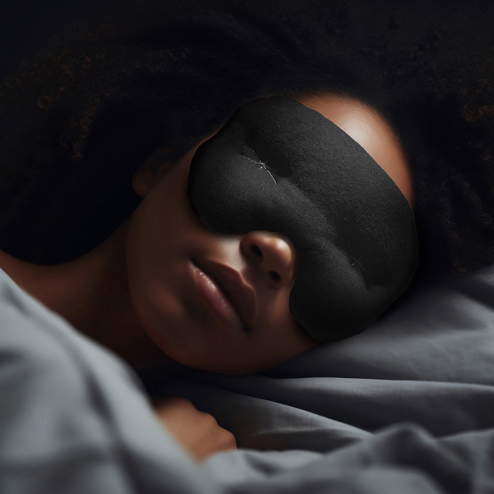 Person sleeping with an  IMAK Eye Pillow Pain Relief Mask on in a dark room