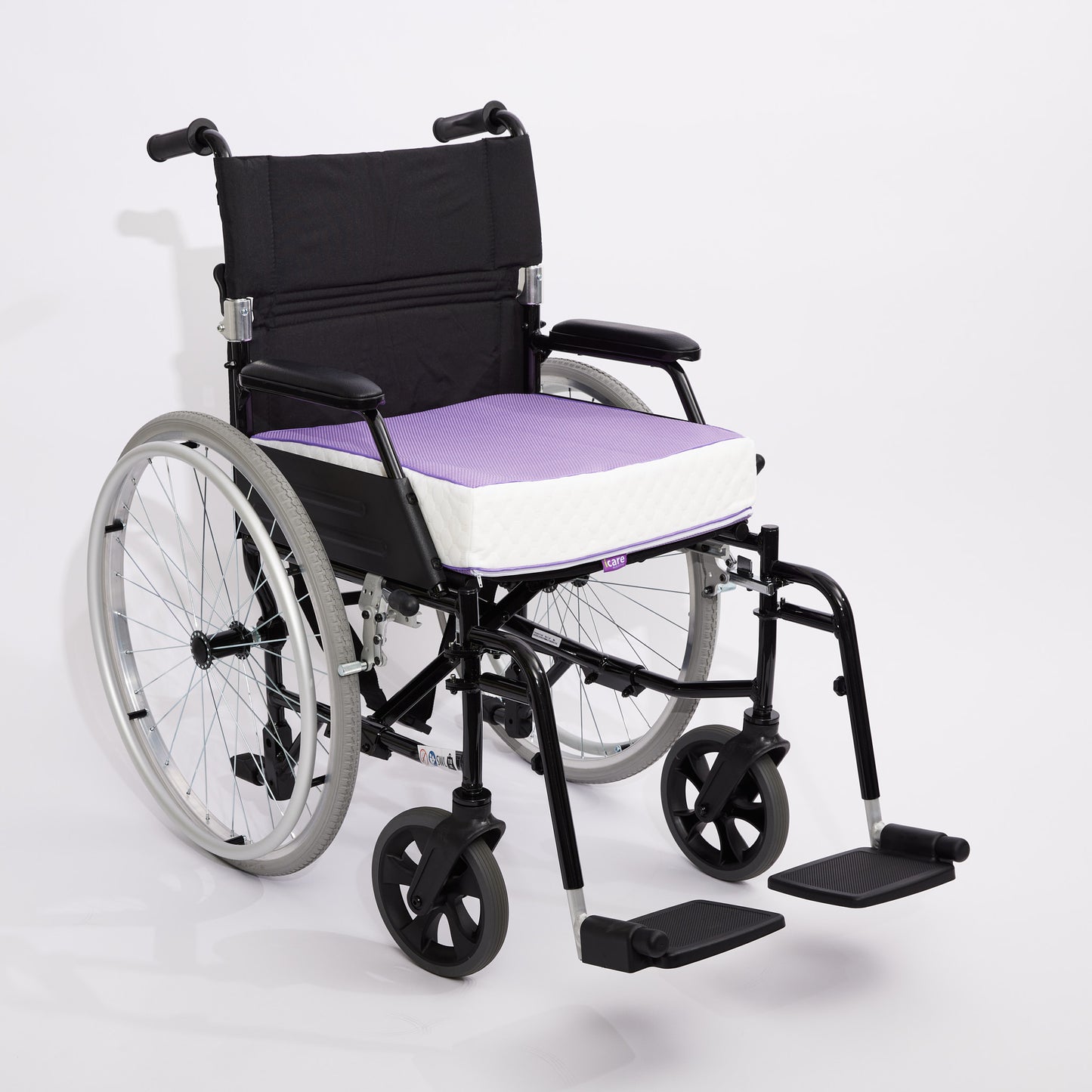 A manual wheelchair with a black frame and backrest, featuring a purple 10cm icare Supporta Seat Cushion, shown on a light gray studio background.