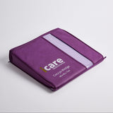 A purple icare Coccyx Wedge with a white reflective stripe and white printed branding, shown on a light gray background.