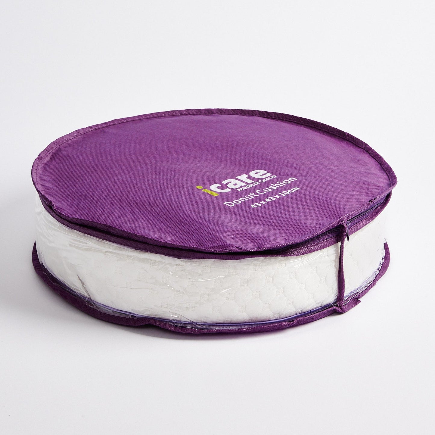 A purple icare Supporta Donut Cushion in packaging  featuring the 'iCare' logo printed on the lid, set against a plain light gray background.