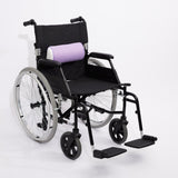 A black manual wheelchair with a light purple icare Supporta half Lumbar Roll, shown on a clean white studio background.
