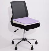 A black mesh office chair with a light purple icare Posture Wedge cushion on a white background.