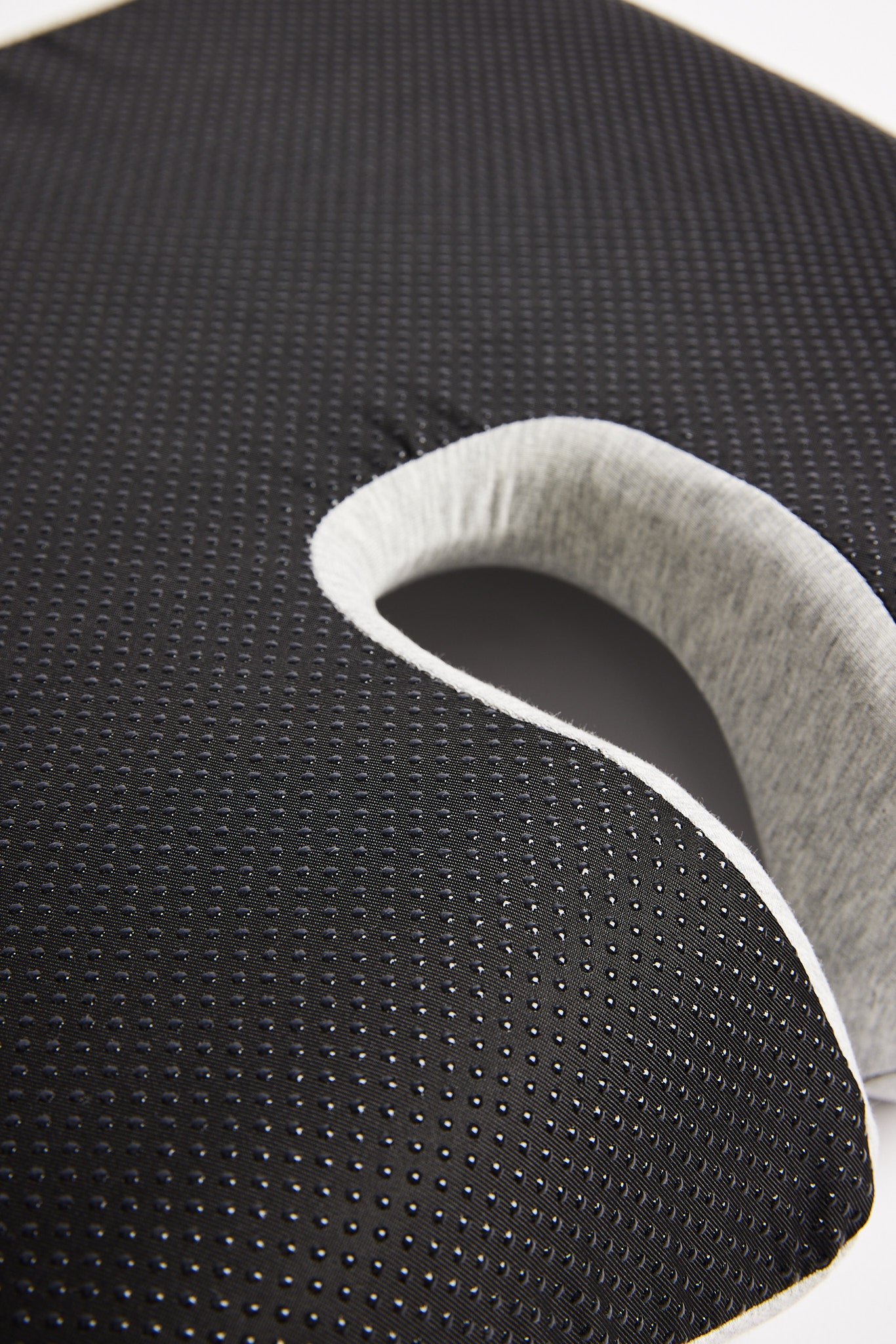 Close-up of a icare Reform Seat Support
 with a non-slip textured surface back.