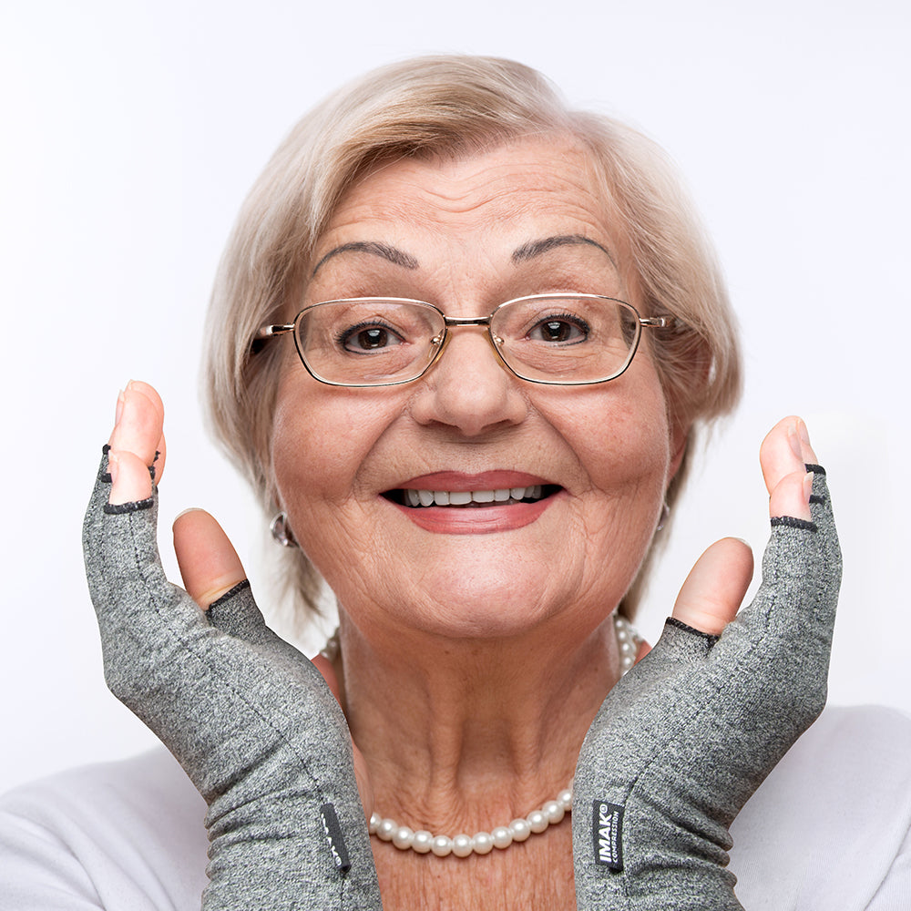 Woman wearing I‑MAK Compression Arthritis Gloves with a white background