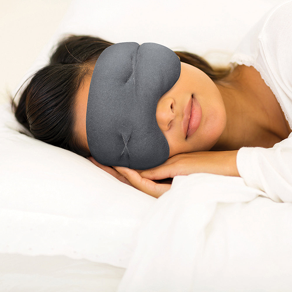 Person wearing an IMAK Eye Pillow Pain Relief Mask while lying down.