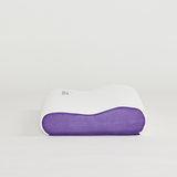 White icare Contour Pillow with purple bottom section on a light gray background