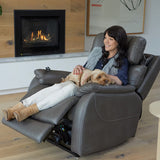 Woman sitting in a Theorem Winslow Power Lift Recliner Chair Smoke with a dog, in front of a fireplace.