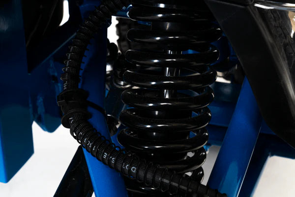 Close-up of a black suspension coil on a Pride Mobility Outback Mobility Scooter