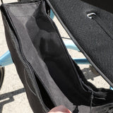 Close-up of a black fabric storage pouch or bag compartment with a zipper, shown outdoors with part of an ice blue Goldfern X-FOLD Rollator walker 