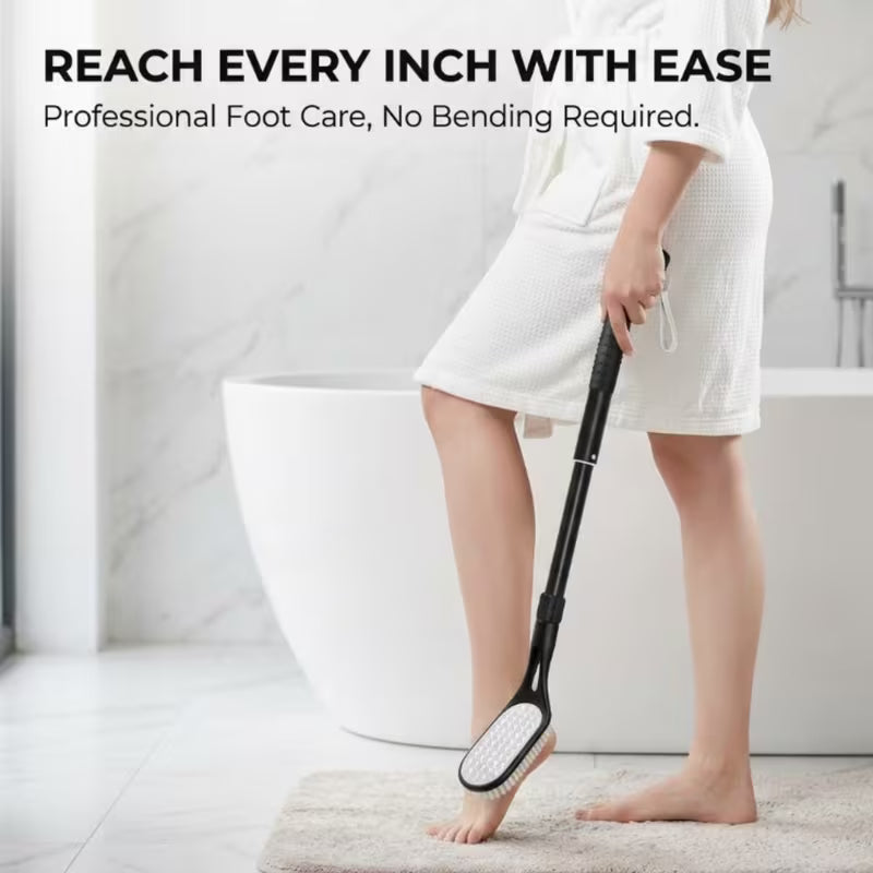 A person in a white robe stands barefoot near a bathtub, holding a black foot care tool with a wide scrubber head. Text at the top reads, 'REACH EVERY INCH WITH EASE' and 'Professional Foot Care, No Bending Required.