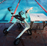 Person swimming in a pool with a byACRE Nordic Pioneer on the poolside