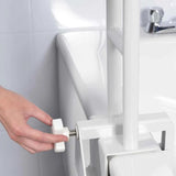 A close-up of a person's hand adjusting a Roma Bath Grab Bar next to a white sink and tiled wall.
