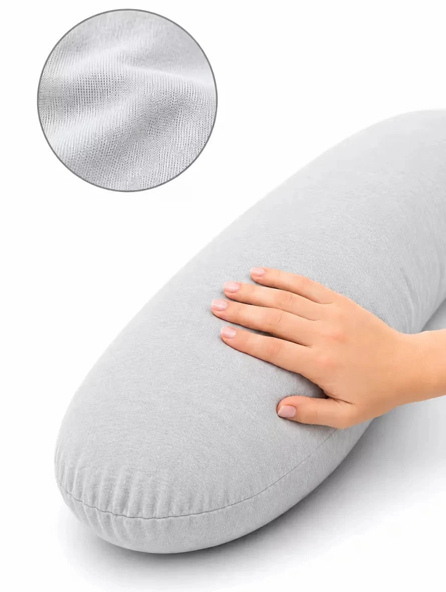 A light gray icare Supporta Body Pillow with a hand resting on its surface, featuring a circular inset showing a close-up of the textured fabric.