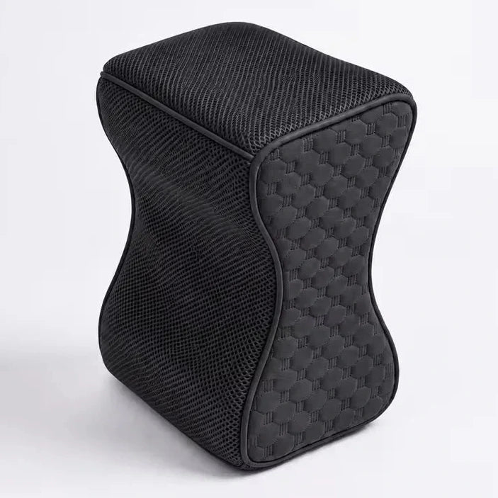 A charcoal icare Supporta Knee Cushion  with a textured mesh fabric cover and a quilted honeycomb pattern on the side, shown on a light gray background.