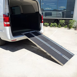 Van with an extended TriFold ramp in a parking lot
