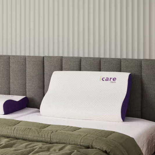 icare Contour Pillow on a bed