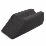 A charcoal icare Leg Raiser pillow with a quilted diamond pattern on the top surface and a textured fabric side, shown on a plain white background.