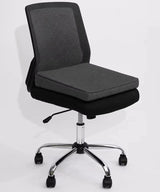 A modern office desk chair with a dark gray fabric mesh backrest, with a charcoal icare Posture Wedge, and a chrome five-star base with black casters, shown against a plain white background.