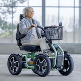 Woman using a STERLING S800 by Scoozy All-Terrain Mobility Scooter in an indoor setting with large windows.