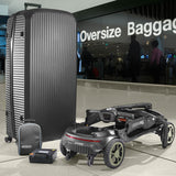 A large black ribbed hard-shell suitcase stands next to a STERLING S50 Carbon Folding Mobility Scooter and matching small bag in an airport terminal. A glass sign in the background reads 'Oversize Baggage'.