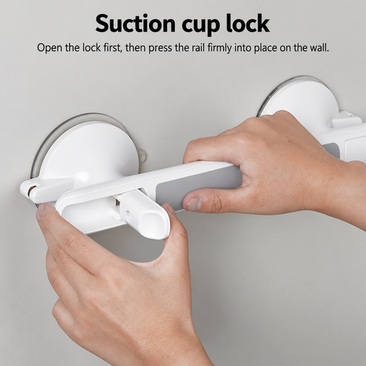 A close-up of a person's hands installing a white suction cup lock rail onto a gray wall, with black instructional text at the top reading 'Suction cup lock' and a subtitle explaining how to open the lock and press the rail into place.